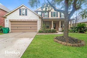 Kingwood house for rent - A house with a large tree in front of it.