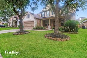 Kingwood house for rent - A house with a tree in front of it.