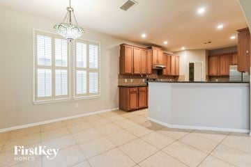 Kingwood house for rent - A kitchen with wooden cabinets and a tiled floor.