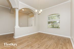 Leesburg house for rent - an empty living room with hardwood floors and a window
