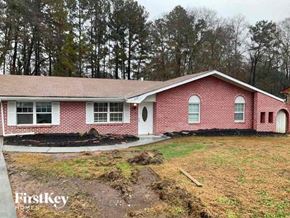 Atlanta house for rent - a red brick house with trees in the background