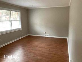 Atlanta house for rent - a empty room with a wood floor and a window