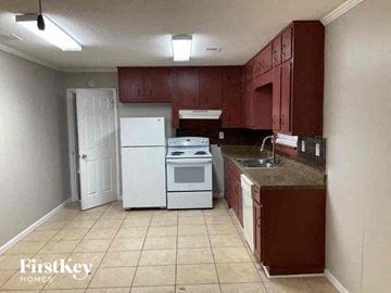 Atlanta house for rent - a kitchen with a stove refrigerator and sink