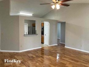 Jacksonville house for rent - an empty living room with a ceiling fan