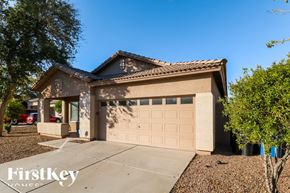 Avondale house for rent - A house with a tan garage door and a brown roof.