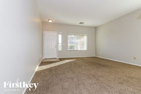Avondale house for rent - A room with a carpeted floor and a door leading to a balcony.