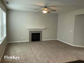 Columbus house for rent - an empty living room with a ceiling fan and a fireplace