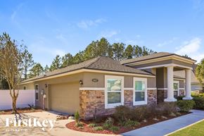Jacksonville house for rent - a bungalow with brick and stone exterior and a driveway