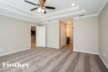 Jacksonville house for rent - a living room with carpet and a ceiling fan