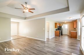 Pleasant View house for rent - A spacious living room with a ceiling fan and wooden flooring.
