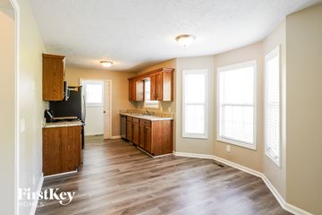 Pleasant View house for rent - A kitchen with wooden cabinets and a refrigerator.