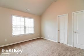 Covington house for rent - a bedroom with carpet and a window and two doors