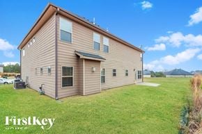 Covington house for rent - a home with a brown and and a grass field