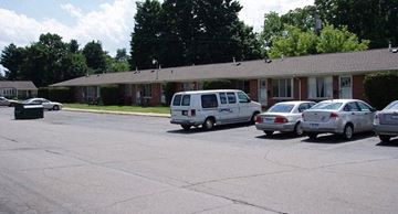Ypsilanti apartment for rent - a parking lot with cars in front of a building