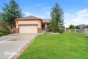 Peyton house for rent - a house with a driveway and a garage door