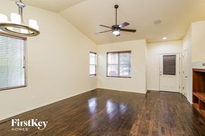 Peyton house for rent - an empty living room with wood floors and a ceiling fan