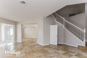 Valrico house for rent - the living room and entryway of a house with a staircase and a door to
