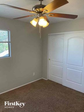 Glendale house for rent - a bedroom with a ceiling fan and a door