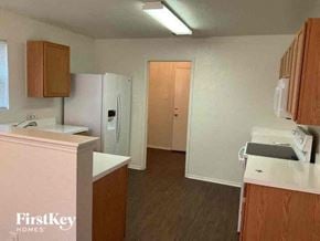 Fort Worth house for rent - an empty kitchen with a refrigerator and a sink