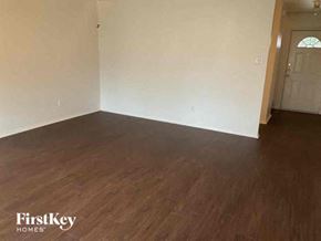 Fort Worth house for rent - an empty living room with white walls and wood floors