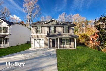 Charlotte house for rent - a suburban house with a driveway and a garage door