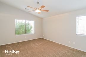Phoenix house for rent - a bedroom with a ceiling fan and a window