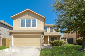 San Antonio house for rent - a tan house with a yellow garage door and a tree