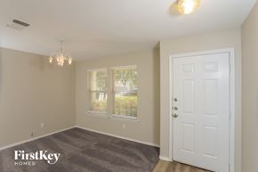San Antonio house for rent - the living room of a house with a white door and window