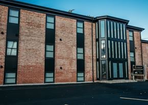 Tonawanda apartment for rent - a brick building with a sign in front of it