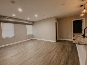 Tonawanda apartment for rent - the living room and dining room of a new home with wood flooring