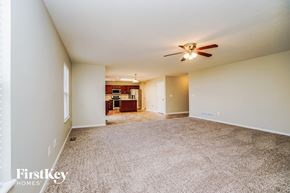 Commercial Point house for rent - an empty living room with carpet and a ceiling fan