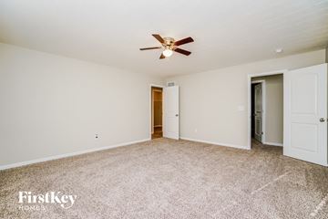Commercial Point house for rent - a spacious living room with carpet and a ceiling fan