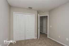 Valrico house for rent - a bedroom with two closets and a door into a hallway