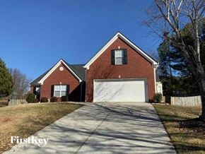 Lawrenceville house for rent - A brick house with a garage door is for sale.