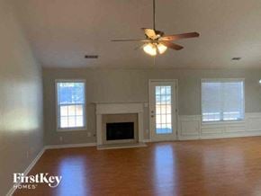 Lawrenceville house for rent - A spacious living room with a fireplace and a ceiling fan.