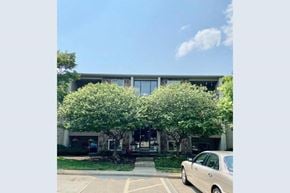West Chester Township house for rent - A car is parked in a parking lot in front of a building.