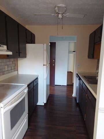 West Chester Township house for rent - A kitchen with a white oven and black cabinets.