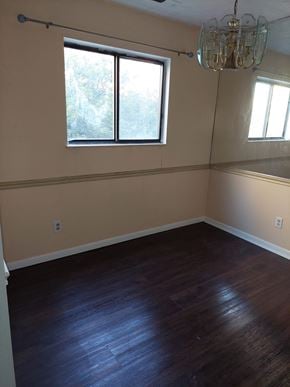 West Chester Township house for rent - A room with a wooden floor and a chandelier.