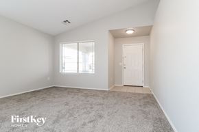 Avondale house for rent - A room with a carpeted floor, a window with blinds, and a door.