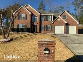 Snellville house for rent - a brick house with a white garage door