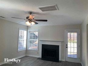 Snellville house for rent - a living room with a ceiling fan and a fireplace