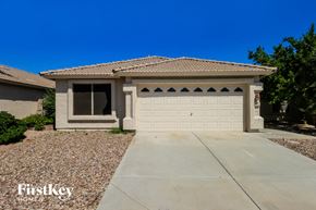 Phoenix house for rent - a house with a white garage door and a driveway