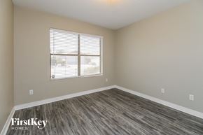 Phoenix house for rent - an empty bedroom with a window and wood flooring