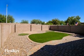 Phoenix house for rent - a backyard with artificial grass and a small lawn