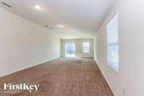Jacksonville house for rent - A spacious room with carpeted floor and white walls.
