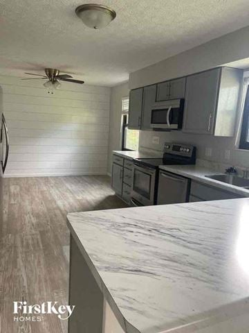 Gahanna house for rent - a kitchen with a marble counter top and stainless steel appliances