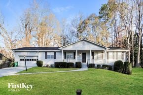 Smyrna house for rent - a white house with a lawn and trees