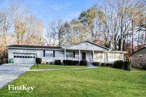 Smyrna house for rent - a white house with a lawn and trees