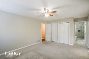 Smyrna house for rent - a living room with a ceiling fan and a door to a bathroom