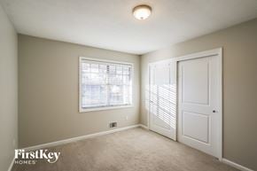 Smyrna house for rent - a bedroom with a large window and a white door